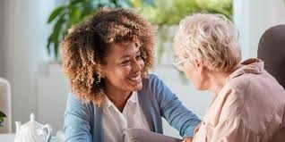 caregiver with senior laughing